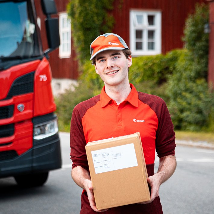 Ung yrkessjåfør holder en pakke